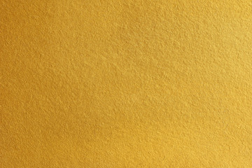Gold paint on rough cement wall texture background