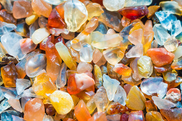 Many raw bright crystals of crystalline silica, colorful transparent quartz stones texture background