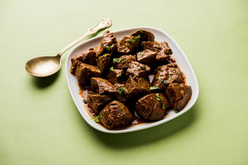 Mutton Liver fry or Kaleji masala, popular Non vegetarian recipe from India and Pakistan. served dry or with curry in a bowl, karahi or plate