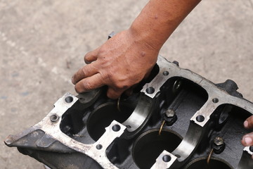 Hand working on car's engine