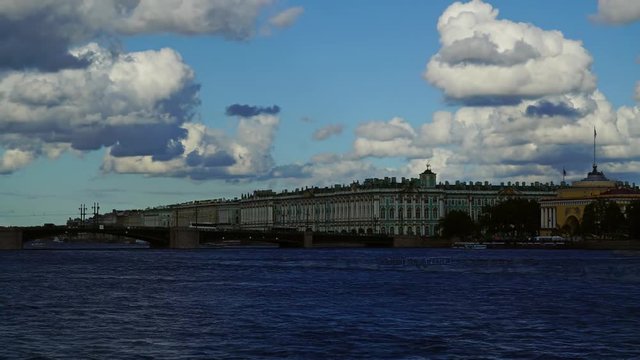 Dramatic cloudy sky over the Neva river in Saint Petersburg, Russia, with the Palace Bridge and Winter Palace - Hermitage Museum, zoom in timelapse 4k