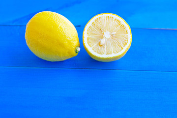 Ripe lemons and limes on blue wooden