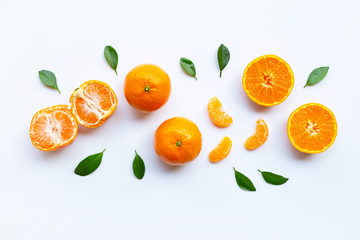 Orange fruits and green leaves on a white background.