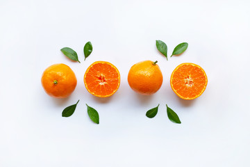 Orange fruits and green leaves on a white background.