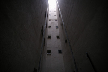 Small bathroom windows in an air vent pit inside a tall communist era block of flats