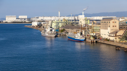 Fototapeta na wymiar industrial facilities and port and corgo ship osaka japan