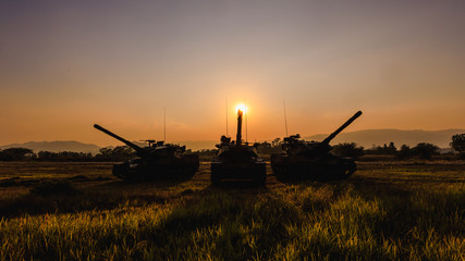 twilight landscape big conon thank and soldiers silhouette over sunset  background