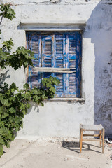 blue boarded village windows in Ikaria, Greece