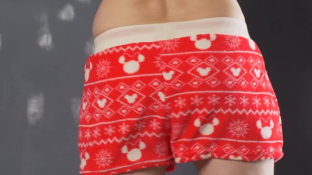 Girl in carnival shorts shakes her booty in front of the camera