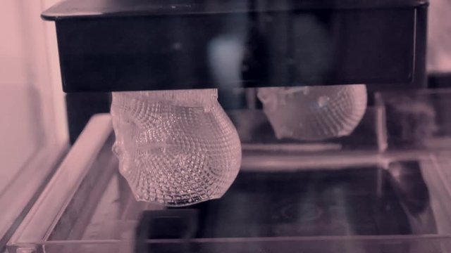 Stereolithography DPL, SLA 3d printer creating shape by UV polymerization close-up. Progressive modern additive technology 3D printing.