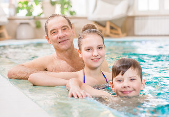 Fototapeta premium Happy family having fun in the pool
