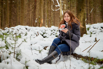 Girl in a pine forest on a winter day