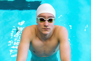 Portrait of a swimmer on the background of the pool.