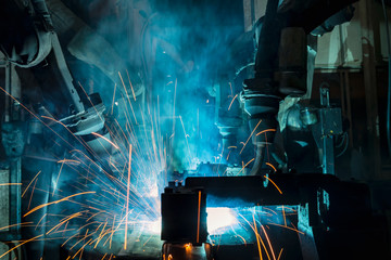 Industrial robot is movement welding steel part in factory