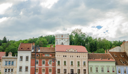 The White Tower with beautiful old historic buildings on the front in Brasov city of Romania