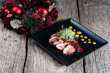 Duck breast, chopped with slices and beautifully presented with cherry sauce