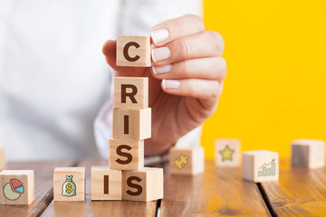 Woman hand arranging wooden cubes with word 