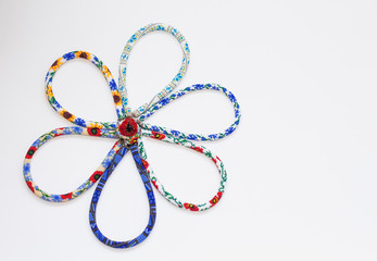 Beaded crochet necklaces with floral pattern on white background. Bead rope, seed beads,