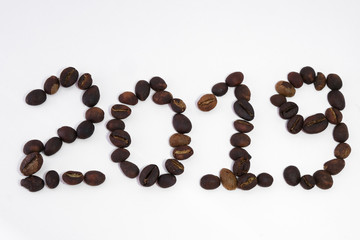 Text 2019 write by coffee beans. Royalty high-quality free stock macro photo image of shape 2019 design text by roasted black coffee beans, coffee beans background. Close-up or macro photo coffee bean