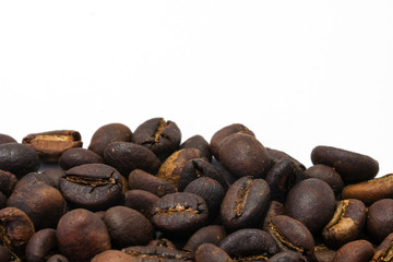 Coffee beans background texture isolated on white background with copy space for text. Royalty high-quality free stock macro photo image roasted brown, black coffee bean isolated on white background