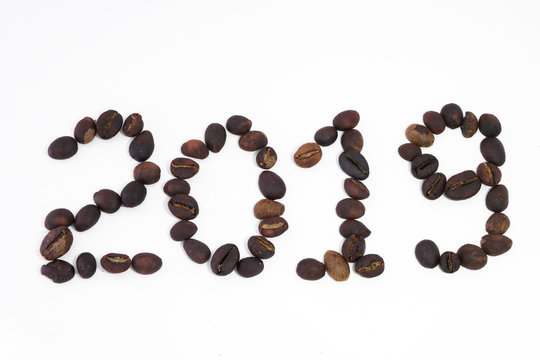 Text 2019 write by coffee beans. Royalty high-quality free stock macro photo image of shape 2019 design text by roasted black coffee beans, coffee beans background. Close-up or macro photo coffee bean