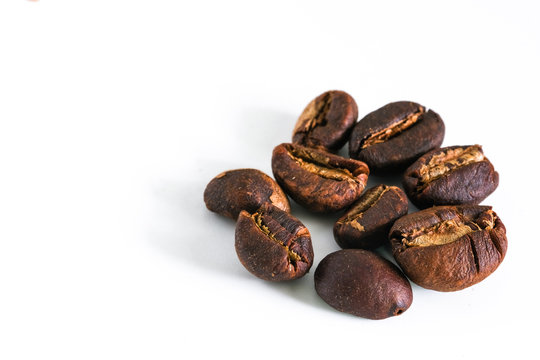 Coffee beans background texture isolated on white background with copy space for text. Royalty high-quality free stock macro photo image roasted brown, black coffee bean isolated on white background