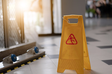 Sign showing warning of caution wet floor in airport.