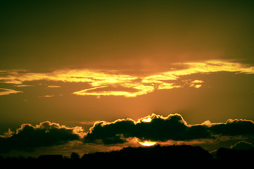 Bright big sun on the sky with clouds
