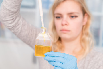 Young attractive woman work with PCR dispenser in  the laboratory of genetics