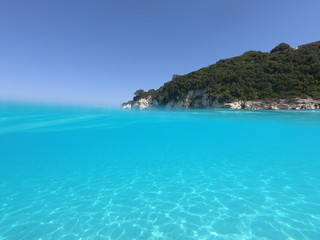 Fototapeta premium Underwater photo of mediterranean paradise island sandy beach with turquoise clear sea