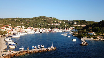 Fototapeta na wymiar Aerial drone bird's eye view photo of iconic small safe port of Gaios with traditional Ionian architecture and sail boats docked, Paxos island, Ionian, Greece