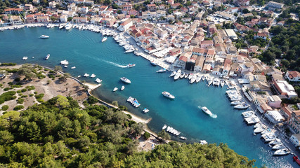 Fototapeta na wymiar Aerial drone bird's eye view photo of iconic small safe port of Gaios with traditional Ionian architecture and sail boats docked, Paxos island, Ionian, Greece
