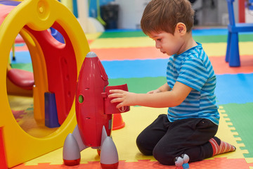 child of three years old is playing in the child's garden. boy smiling spends fun time in the...