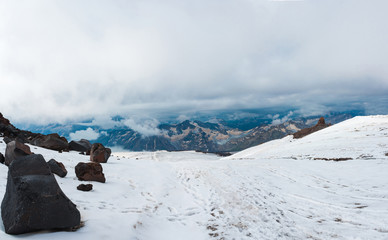 Snow and ice landscape in Caucasus mountains in cloudly weather
