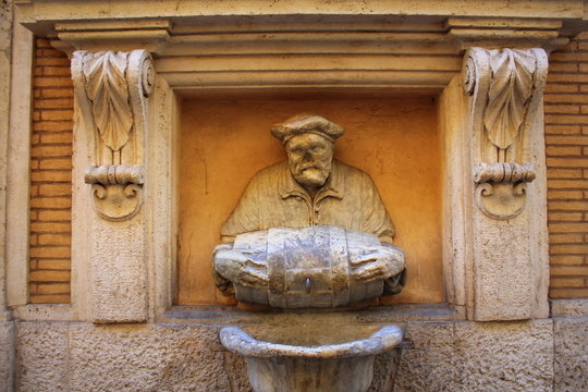ROME, ITALY - December 28, 2018: Statue of an old man pouring water from a barrel used as a fountain nicknamed 'The Porter'. It was made in 1580 and used as a site to post satirical writings.