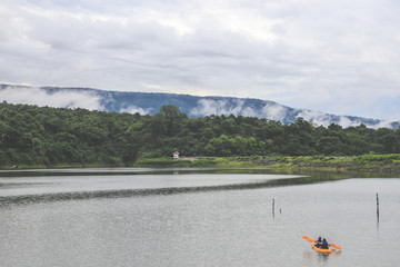 Fototapeta na wymiar Kayaks in the lake. Tourists kayaking on the Bay of nakornnayok thailand.