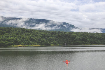 Kayaks in the lake. Tourists kayaking on the Bay of nakornnayok thailand.
