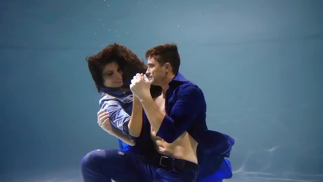 Romantic shoot of a beautiful couple under water.