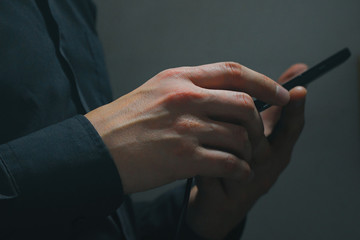 Man uses a smartphone in a dark room