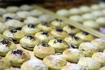 Rows of traditional Chinese cake in oval shape with various nut cream fillings in the box