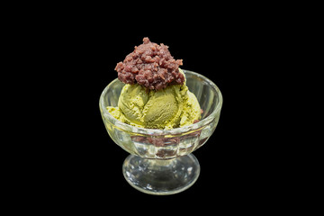 Green tea Ice cream topping with red bean put in the glass cup, die cut in black background