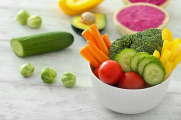 Bowl with fresh vegetables on table. Diet food