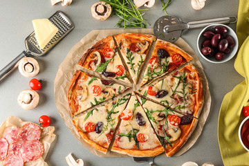 Delicious pizza and ingredients on table