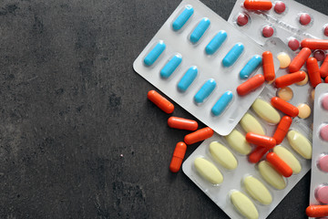 Different pills on grey background