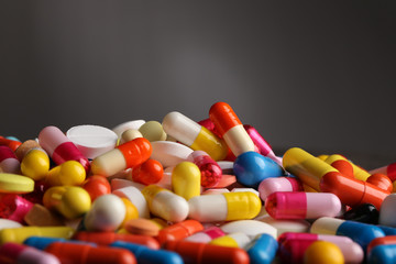 Colorful pills on grey background