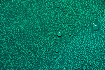 Abstract bright water drops texture on green blue cyan background