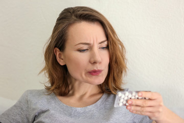 Young woman with pills, closeup