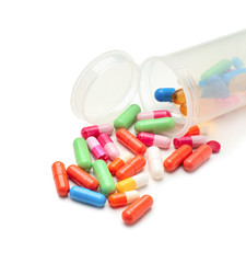 Container with color pills on white background