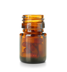 Glass bottle with pills on white background