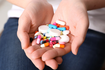 Woman with pills, closeup